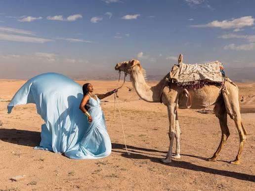 Light blue flying dress photoshoot with a camel in the Agafay desert